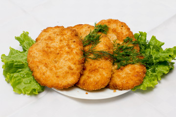 Chicken cutlets on lettuce leaves