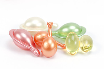 Multi-colored vitamins on white background