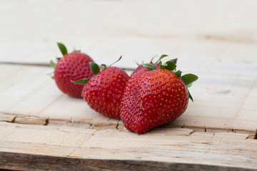 fresh local strawberries macro shot on rustic wooden background