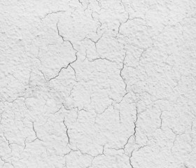 Texture of a grey cement wall with cracks.