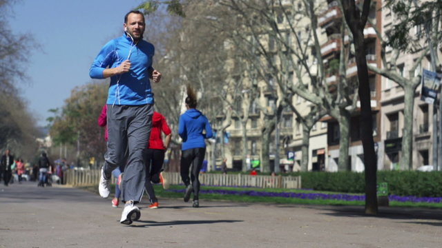 Joggers passing each other, slow motion shot at 240fps, steadyca