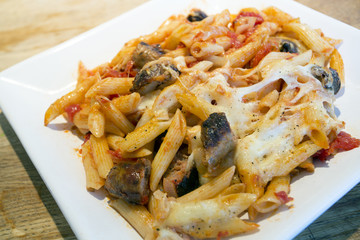 sausgae and tomato and mozzarella cheese pasta bake
