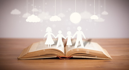Cardboard figures of the family on opened book