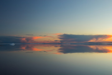 Fototapeta premium Melting spring mountain lake in the setting sun.