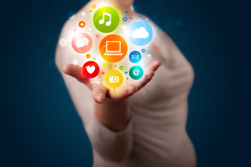 Young woman presenting colorful technology icons and symbols