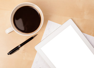 Tablet pc with empty space and a cup of coffee on a desk