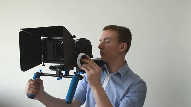 man films with professional camera and smile