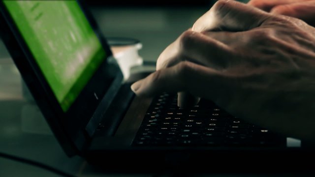 Hacker typing program   on a laptop keyboard