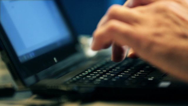 Hacker typing program   on a laptop keyboard