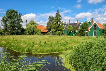 Obraz premium Small creek and rural houses in Dutch village.