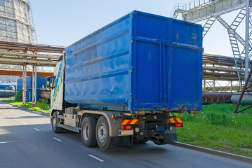 Blue truck drives near the thermal plant.