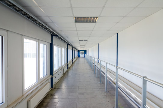 Long corridor with door at end.