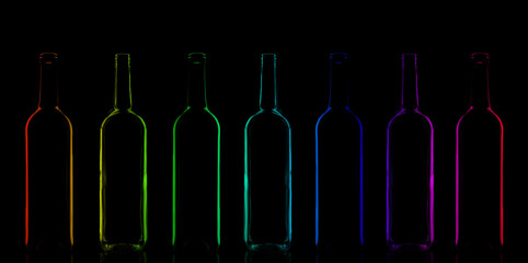 Row of rainbow colored bottles