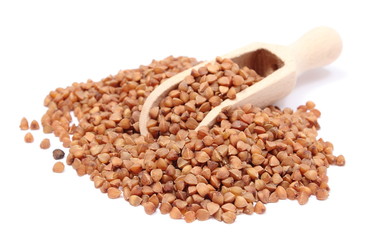 Buckwheat with wooden spoon isolated on white background