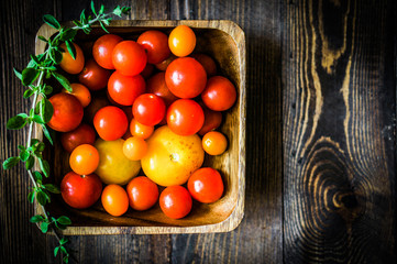 Fototapeta na wymiar Colorful tomatoes on rustic background