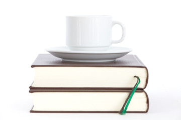 white cup of coffee and book on white background