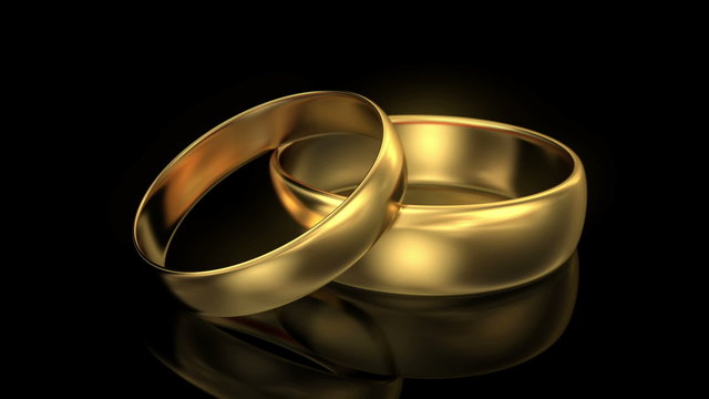 Zoom in wedding rings on black background. 3d animation