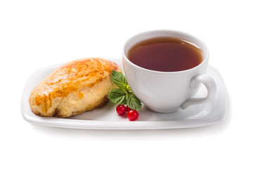 Cup of black tea and cake with apple jam on a white background