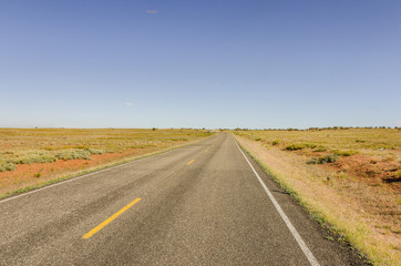 Straight Road Through the Open Plains at Sunset