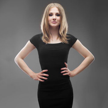 portrait of a young beautiful woman in black dress isolated