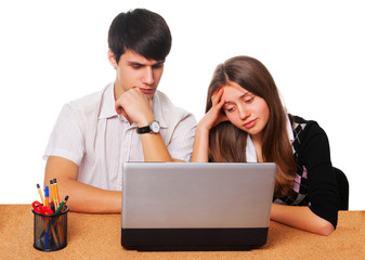 Tired young students studying  isolated over white