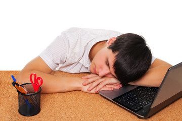 Tired student boy sleeping on the table