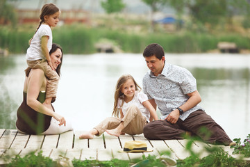 Family resting near pond