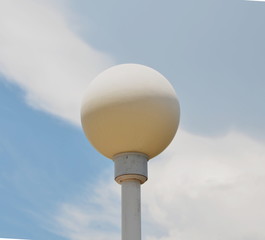 lamppost and white cloud in the blue sky