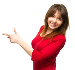 Portrait of a young woman pointing to the left