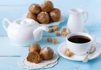 brown buns on blue wooden table with coffee cup