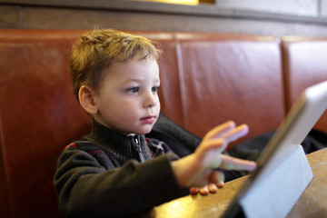 Fototapeta na wymiar Child playing on a Tablet PC