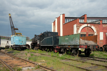 Fototapeta na wymiar TE-3162 steam locomotive with open wagon and crane at depot