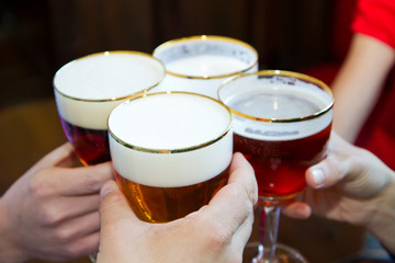 Four friends with a fresh beer 