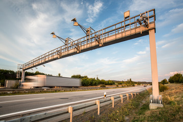 Fototapeta na wymiar Truck passing through a toll gate on a highway