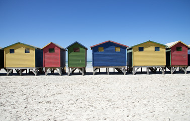 Fototapeta na wymiar Wooden beach huts in various colours at Muizenberg Western Cape