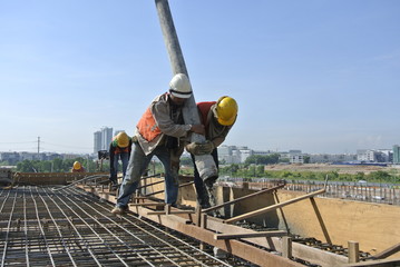 Two Construction Workers Doing Concreting