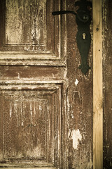 Closeup old wooden door with metal handle