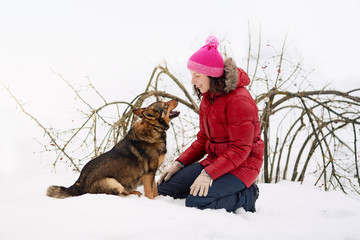 Happy young woman and her dog looking at each other