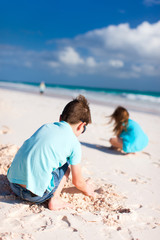 Two kids playing with sand