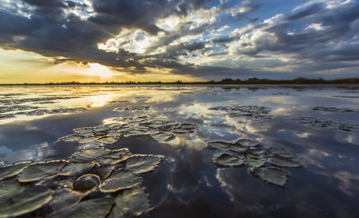 Ominous stormy sky reflection over natural lake