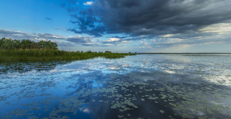 Ominous stormy sky reflection over natural lake