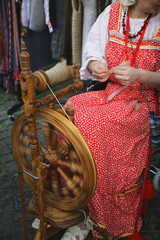 the woman makes the yarn on the machine
