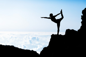 Woman doing yoga sunset silhouette