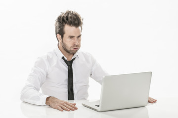 expressive young businessman working on his laptop
