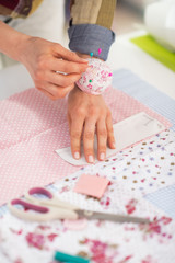 Obraz na płótnie Canvas Closeup on seamstress working with fabric