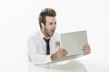 expressive young businessman working on his laptop