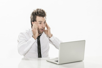 expressive young businessman working on his laptop