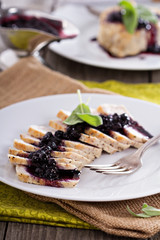 Sliced roasted pork served with berry sauce