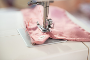 Closeup on seamstress sewing machine