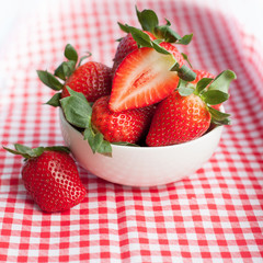 Small bowl filled with succulent juicy fresh ripe red strawberri